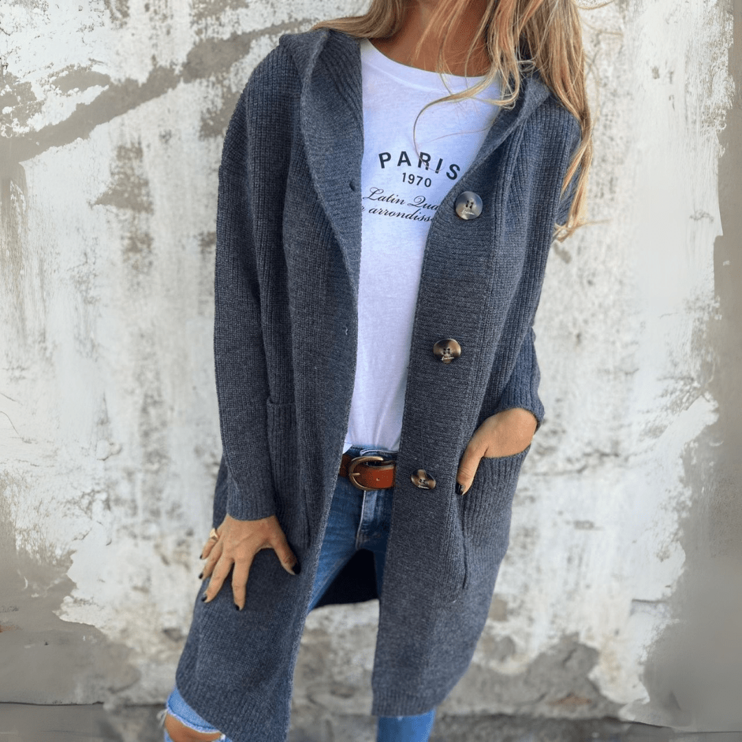 Back view of a women's long chic cardigan, highlighting its flowing silhouette and comfortable outerwear design.