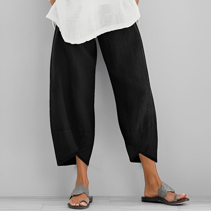 Stylish women's wide leg trousers with a unique asymmetric design, ideal for a trendy and comfortable look.