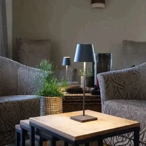 LumoGlow wireless LED lamp illuminating an outdoor dining area, rechargeable & portable.
