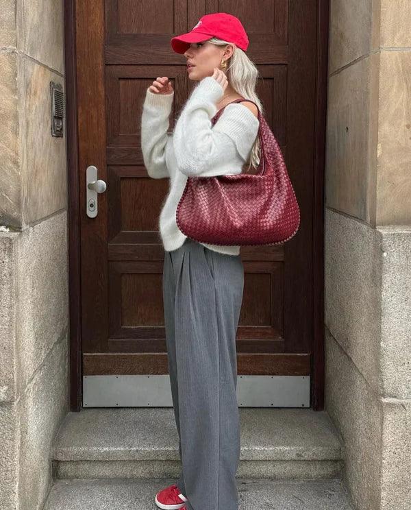 Stylish women's woven vegan leather shoulder bag, a versatile fashion accessory.