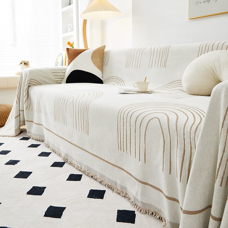 Luxurious sofa throw cover for sectionals, elegantly draped in soft, stretchable fabric, ideal for modern home decor.