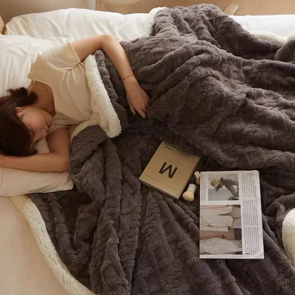 Luxurious, inviting plush winter blanket folded, ready to provide cozy warmth and soft comfort for any home.