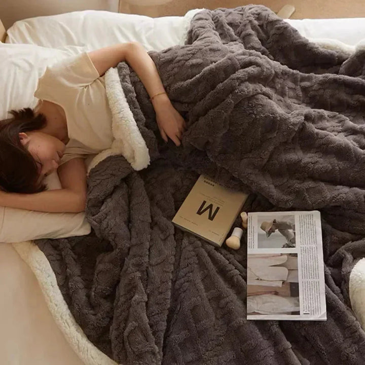 Luxurious, inviting plush winter blanket folded, ready to provide cozy warmth and soft comfort for any home.