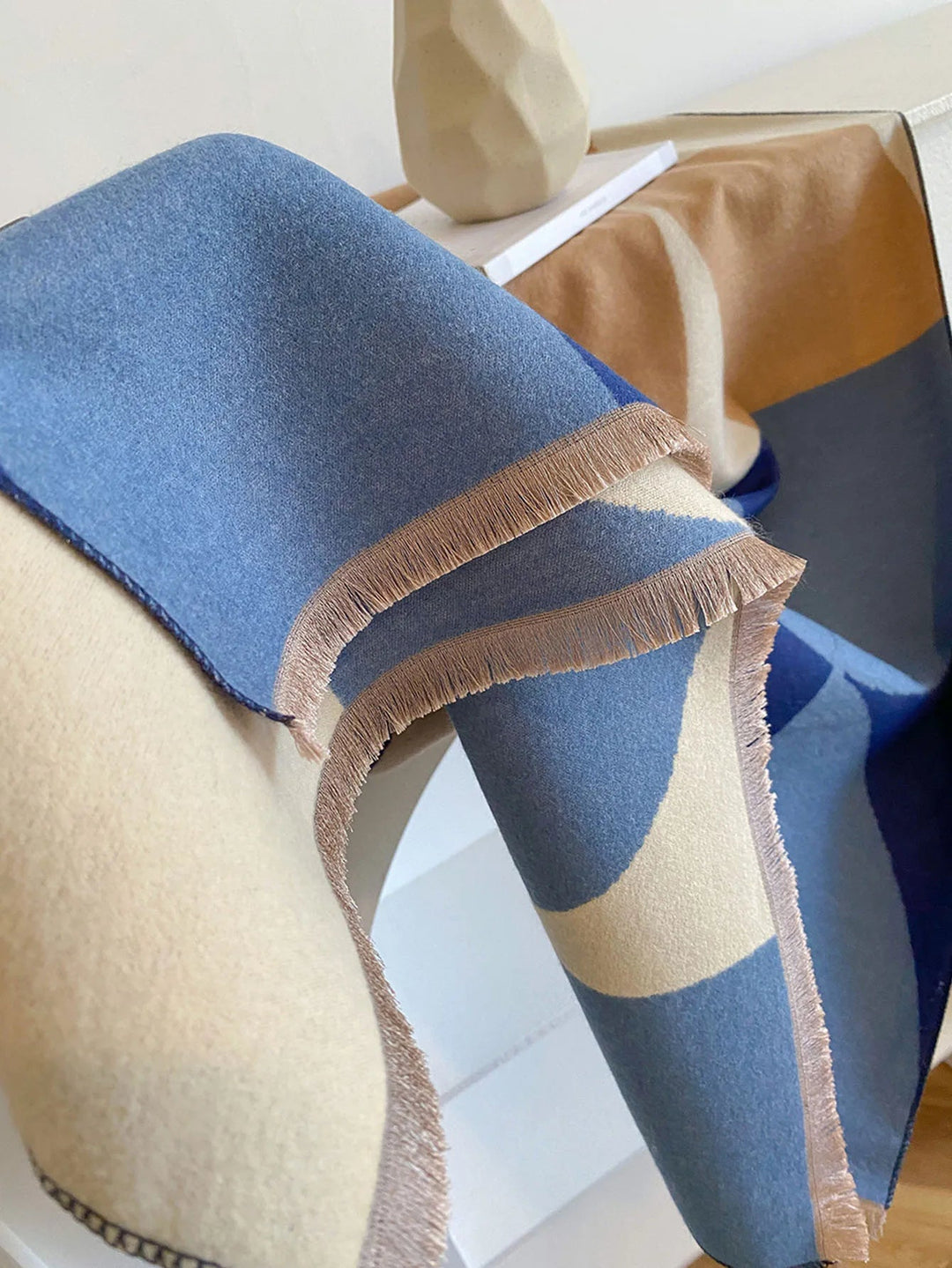Fashionable reversible cashmere scarf for women, providing warmth and a touch of luxury in fall/winter.