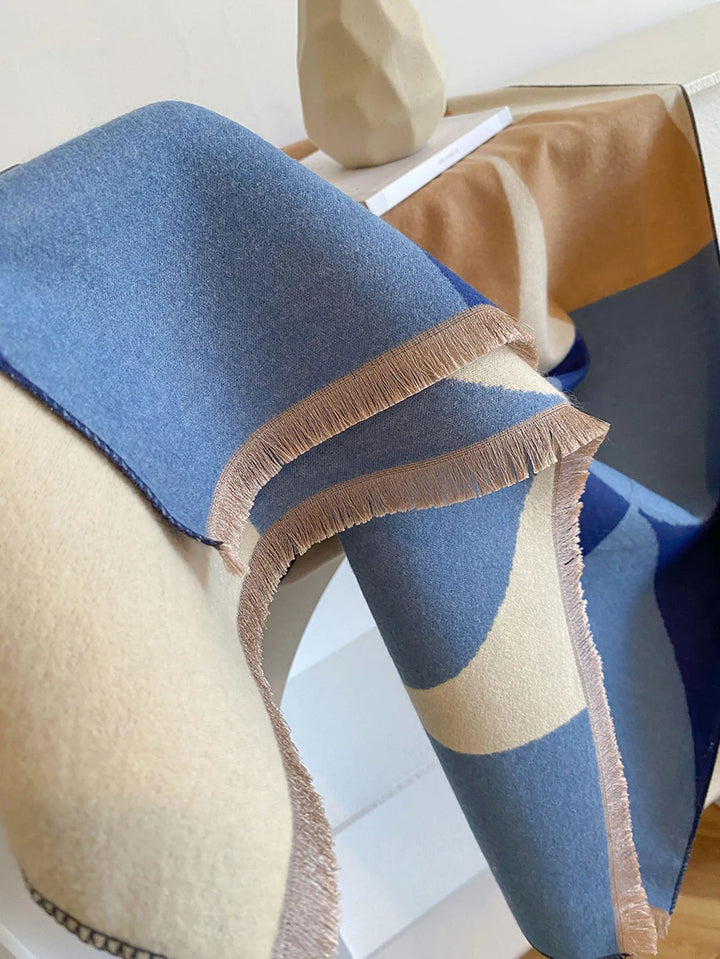 Fashionable reversible cashmere scarf for women, providing warmth and a touch of luxury in fall/winter.