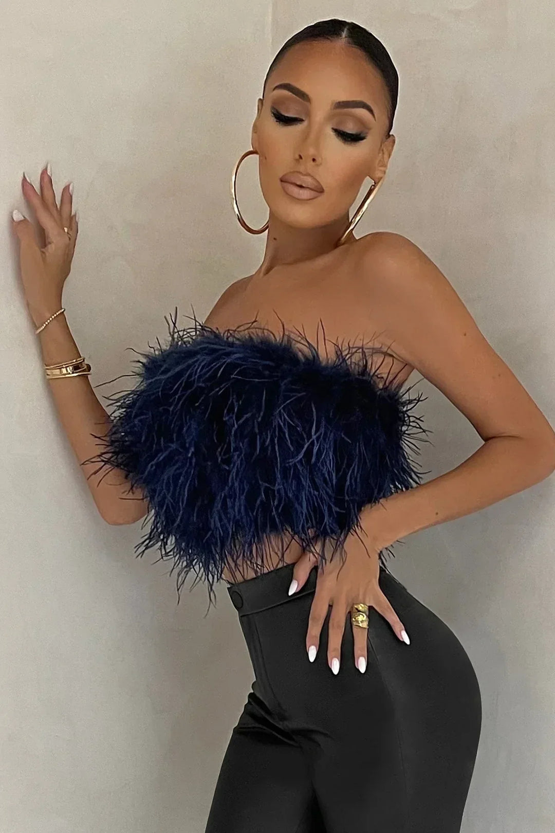 Luxurious feather-detail tube top, an elegant women's fashion statement piece.