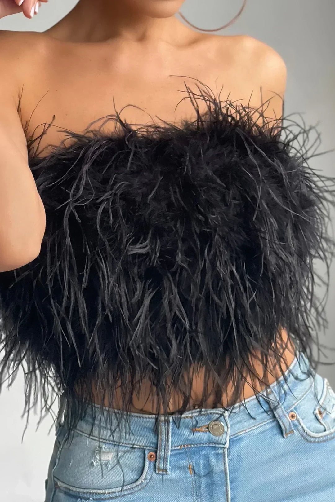 Fashion-forward feather-detail tube top, an elegant choice for women's events.