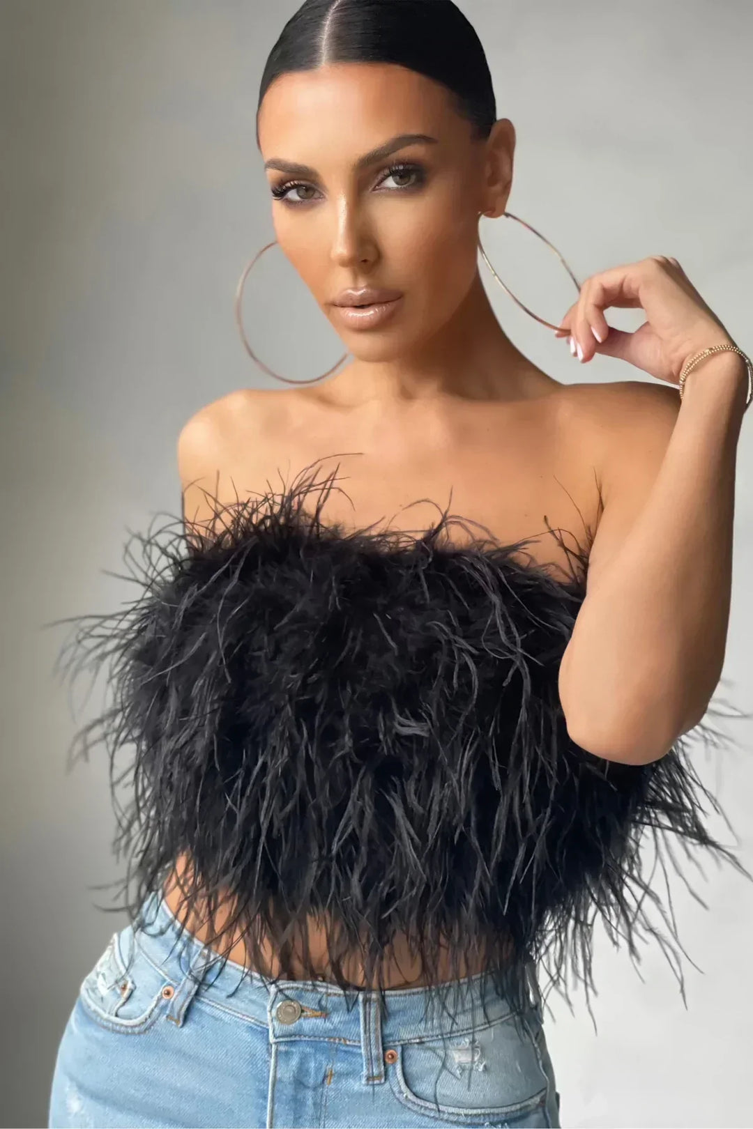 Stylish feather-detail crop top, a fashionable women's party wear essential.