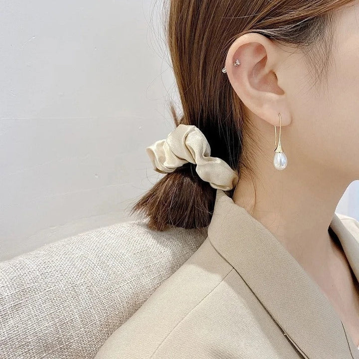 Classic white pearl drop earrings for women, elegant fashion accessory, perfect for any occasion.