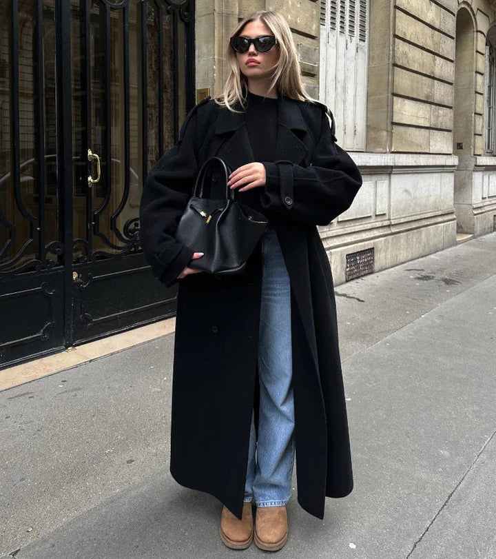 Classic black women's double-breasted trench coat with a belted waist. Elegant fall & spring outerwear.