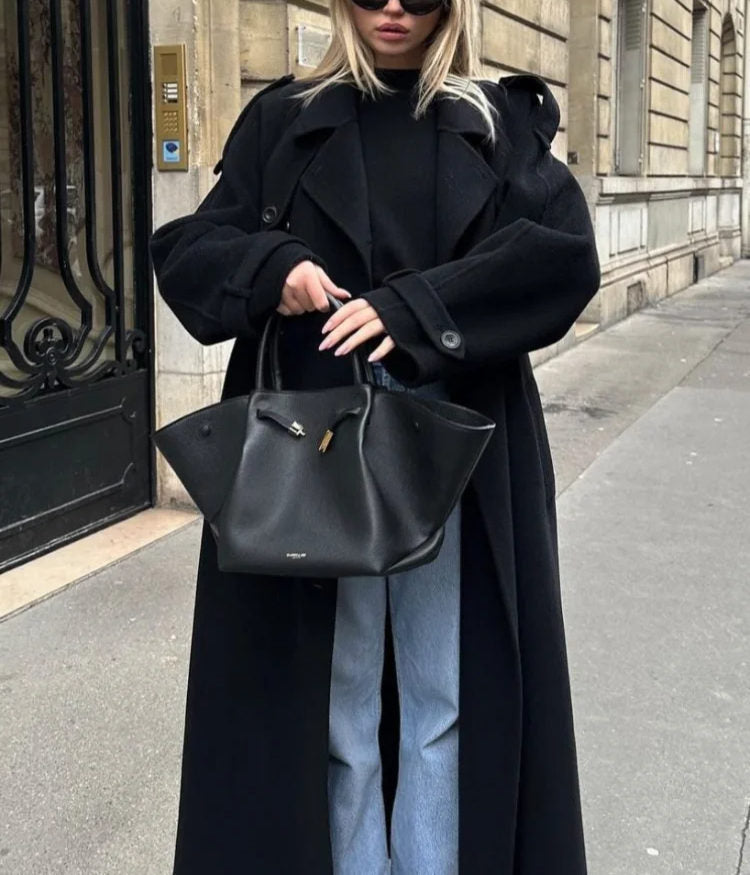 Timeless black women's long trench coat. Double-breasted design with a stylish belted waist, perfect elegant outerwear.