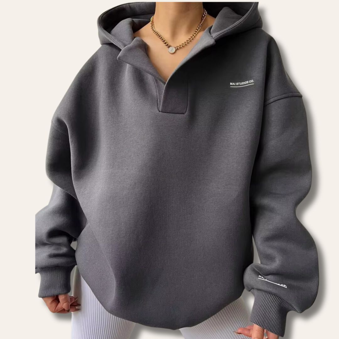 Cozy women's oversized hoodie. Comfortable pullover with chic notch neck for everyday wear.