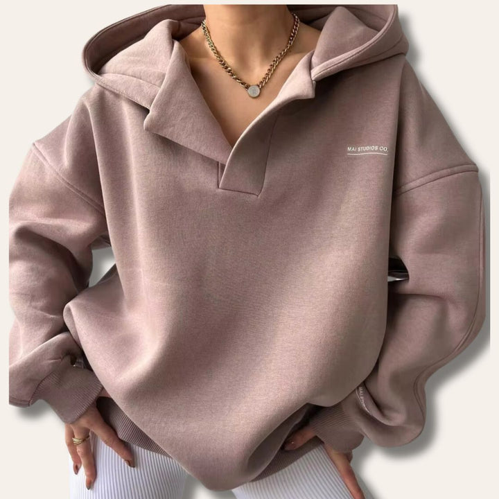 Casual chic women's oversized hoodie. Soft pullover with a fashionable notch neck for comfort.