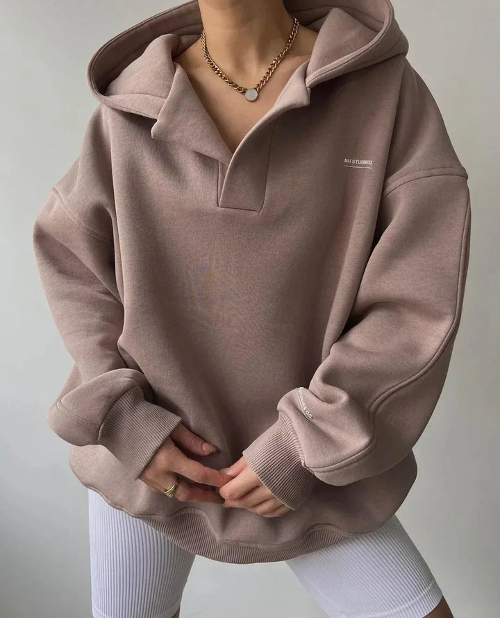 Relaxed fit women's oversized hoodie. Pullover design with a unique notch neck and drop shoulders.