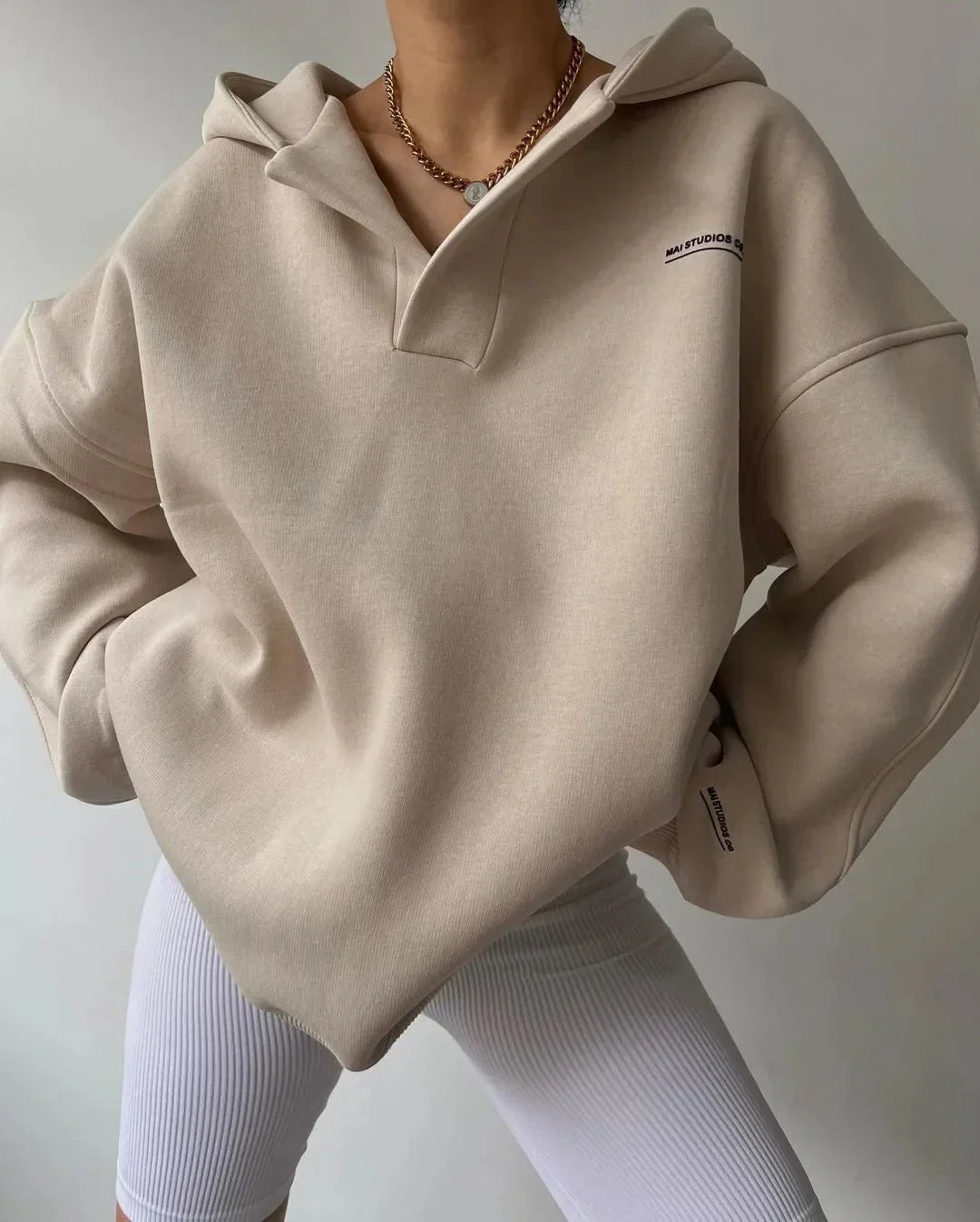 Women's comfortable oversized pullover hoodie. Features a trendy notch neck and relaxed fit.