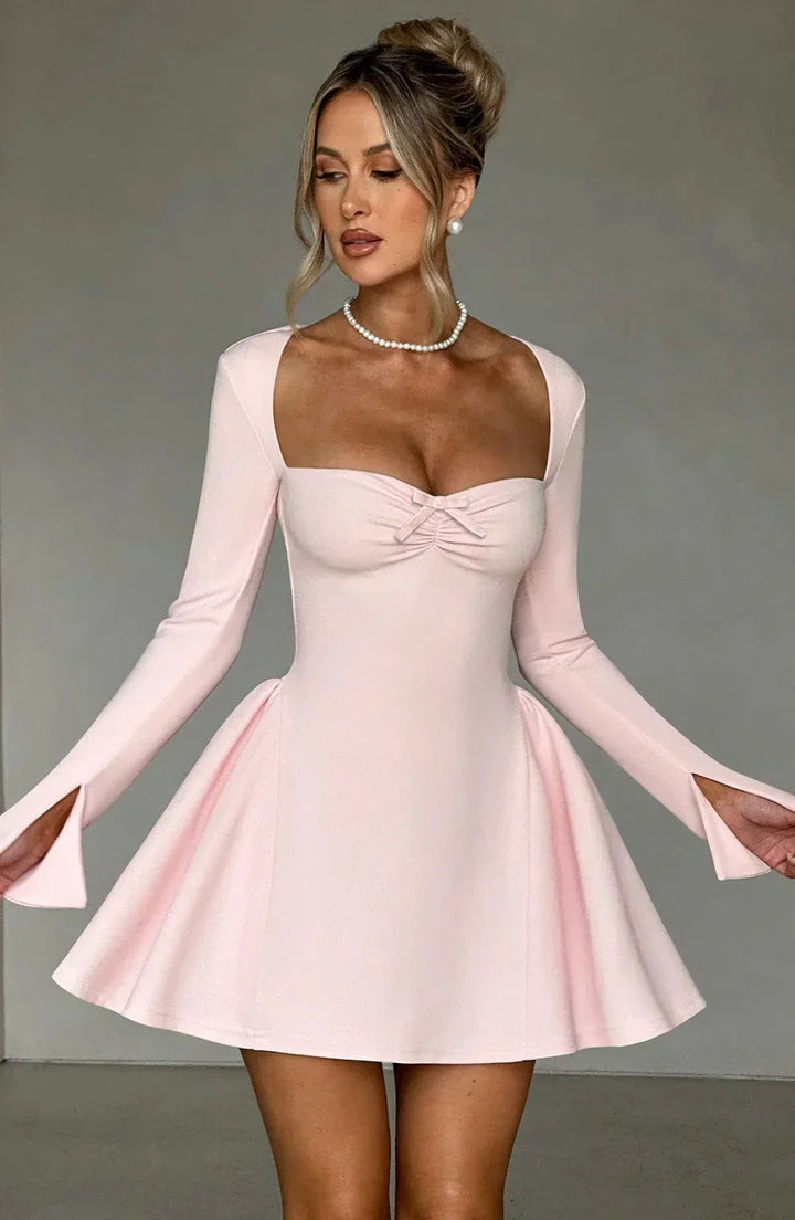 Front view of sophisticated women's pleated A-line long sleeve mini dress. Autumn party essential.