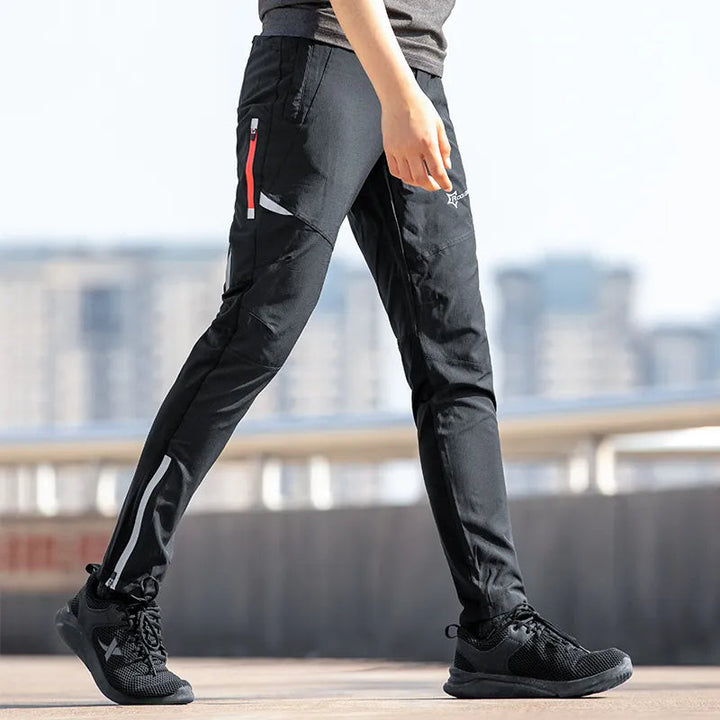 Men's black breathable stretch cycling trousers with reflective design for enhanced visibility & performance.