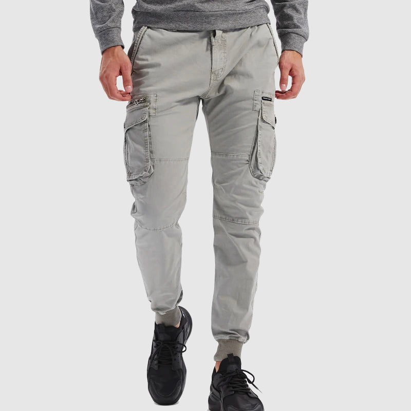 Active men's black cargo joggers. Comfortable pants for exercise or casual wear, featuring an elastic waistband.