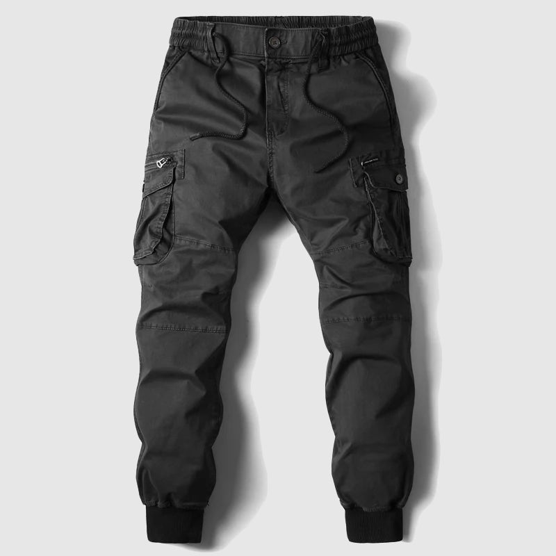 Close-up of black cargo joggers, highlighting soft fabric. Versatile men's pants for any comfortable occasion.