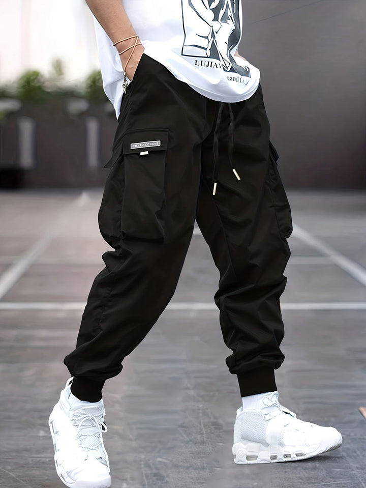 Men's black utility cargo pants with drawstring waist, multiple pockets, and relaxed fit for casual wear.