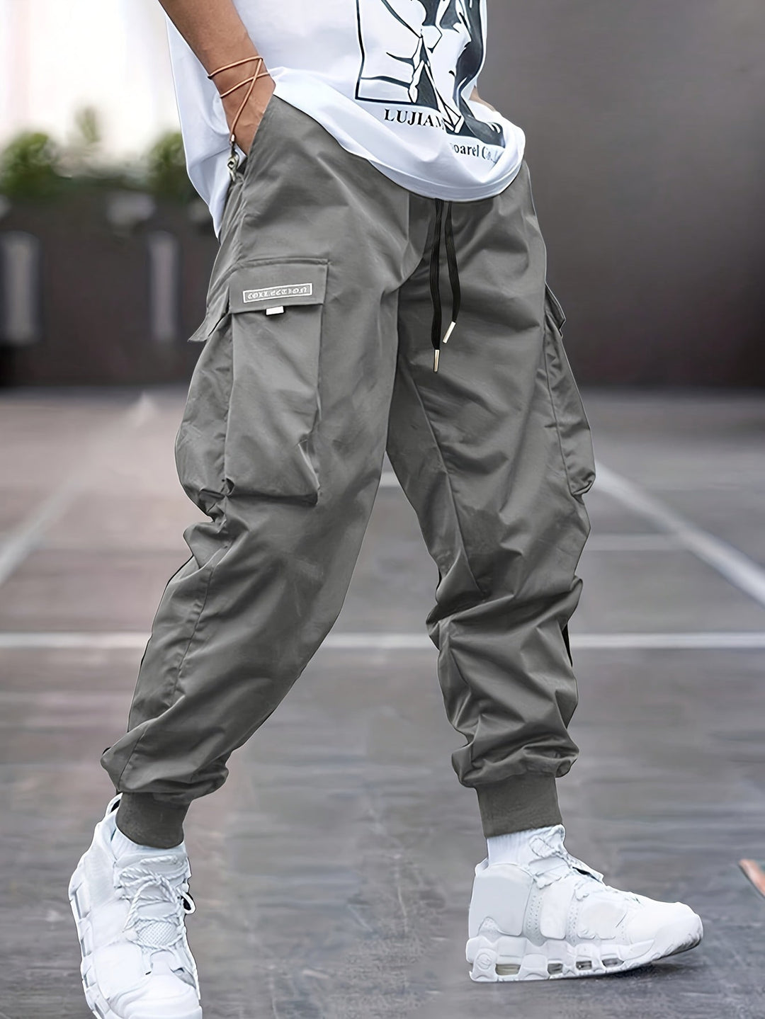 Comfortable men's gray drawstring cargo trousers, ideal for streetwear, casual outings, or active adventures.