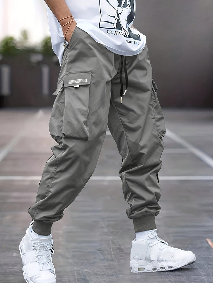 Comfortable men's gray drawstring cargo trousers, ideal for streetwear, casual outings, or active adventures.