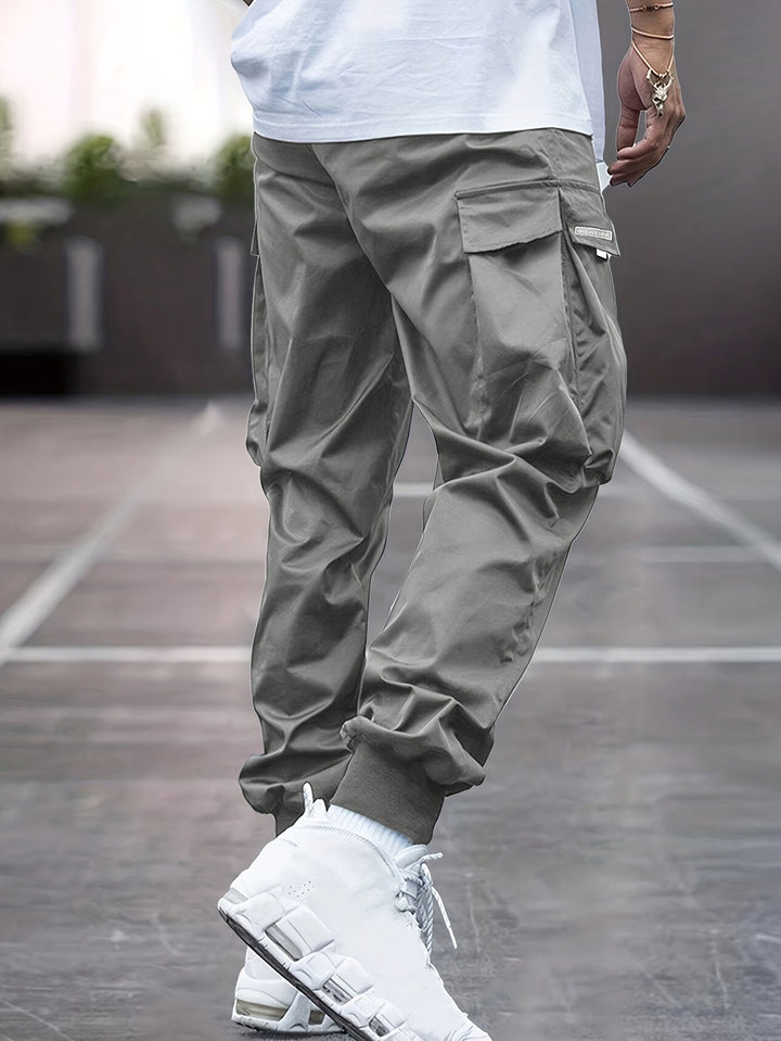 Khaki men's multi-pocket utility cargo pants, featuring a drawstring waist for ultimate comfort & activewear.