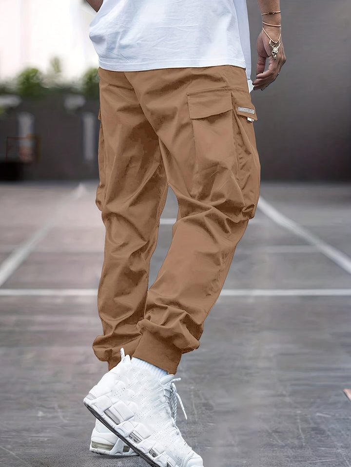 Stylish men's cargo trousers with drawstring, utility pockets, and comfortable relaxed fit for everyday casual wear.
