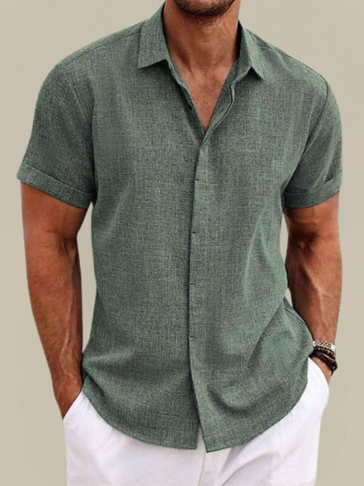 Lightweight men's short sleeve button-up shirt. Breathable fabric ensures comfort for warm weather outfits.