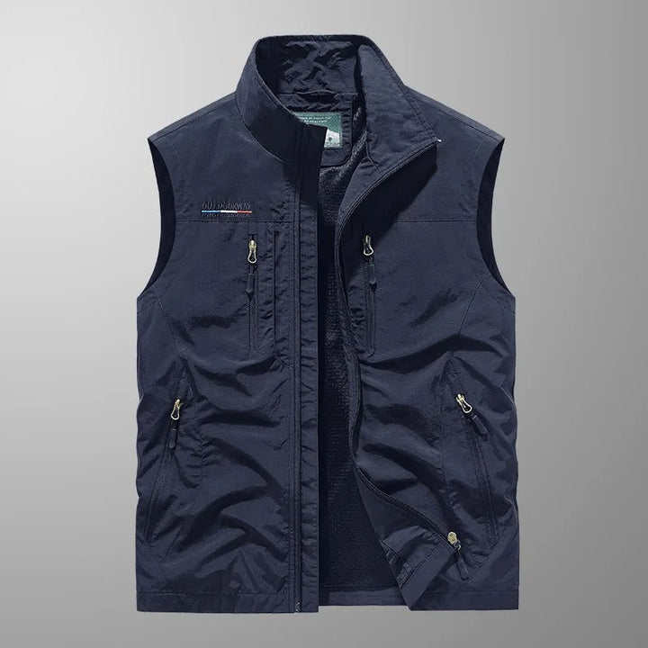Man wearing a breathable multi-pocket cargo vest for outdoor adventure. Ideal for hiking, fishing, and travel.