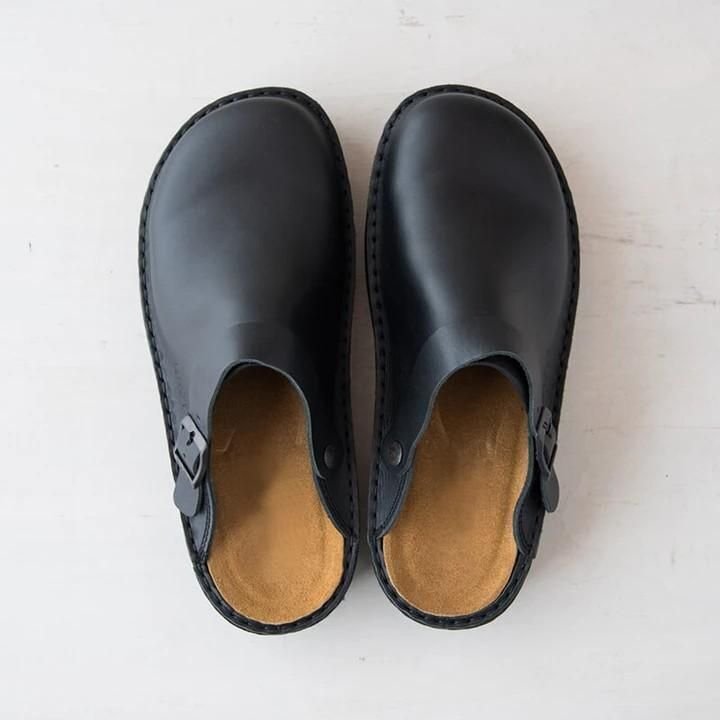 Side view of comfortable men's casual slip-on clogs. Mules with an adjustable buckle for everyday lounge wear.