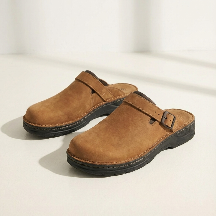 Easy wear men's slip-on clogs, a casual mule design with an adjustable buckle. Comfortable everyday footwear.