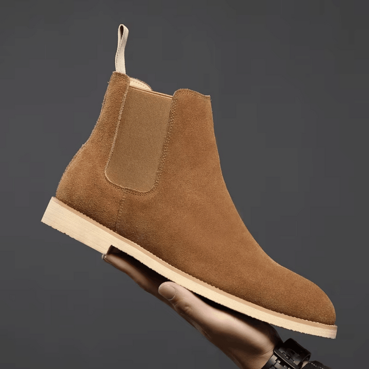Stylish men's black leather Chelsea boots with elastic side panels, perfect for smart casual outfits.