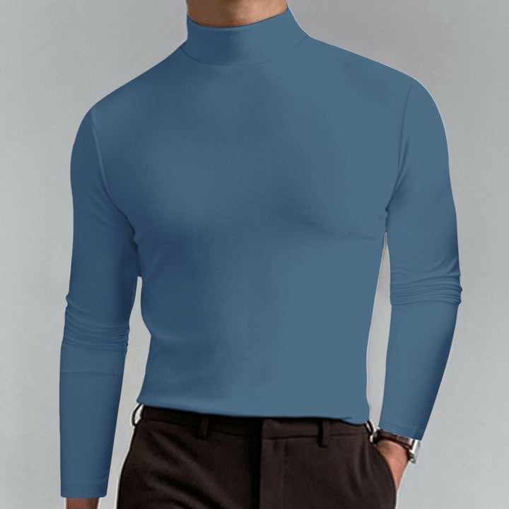 Elegant black men's turtleneck sweater worn under a blazer, versatile for professional and formal wear.