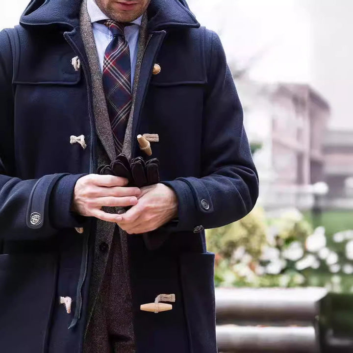 Classic men's duffle coat, dark color, with prominent toggle buttons and a relaxed fit. Stylish winter jacket for men.