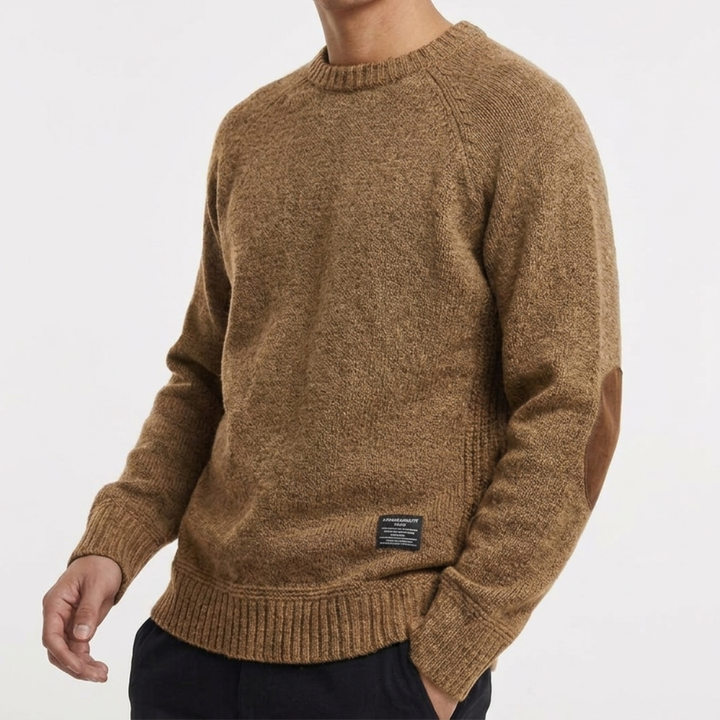 Men's classic knit jumper with corduroy elbow patches, showcasing its timeless and versatile style.