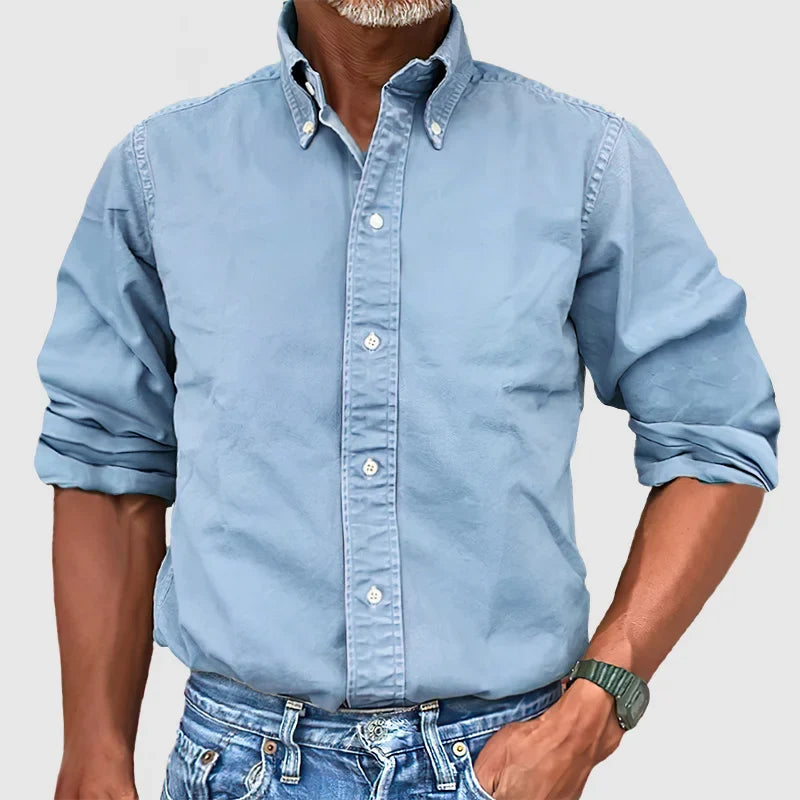 Neatly folded men's classic long-sleeve shirt, ready for wear, emphasizing quality and style.