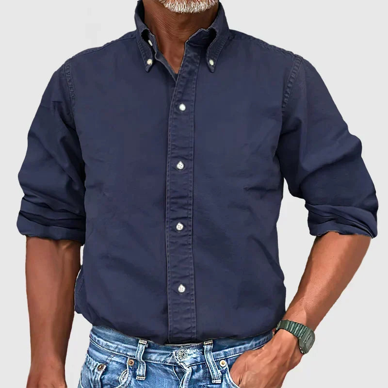 Close-up of a men's classic long-sleeve shirt, featuring clean buttons and a structured collar.