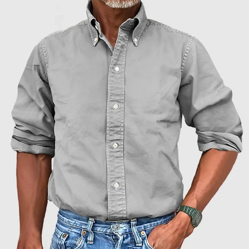 Man wearing a well-fitted classic long-sleeve shirt, showcasing its comfortable and effortless style.