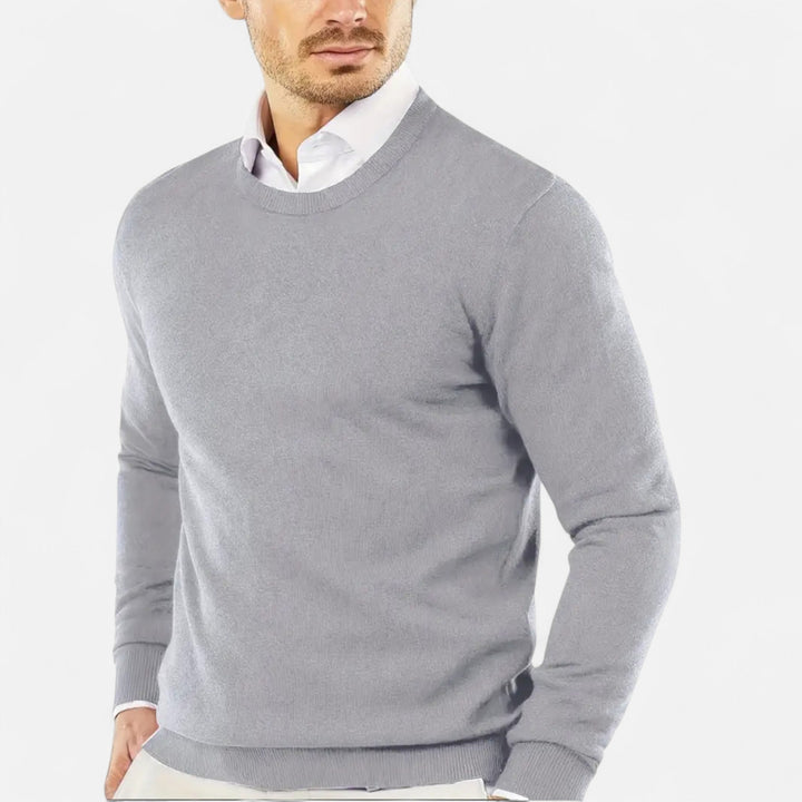 Man wearing a classic round neck knit sweater. Perfect long sleeve pullover for winter comfort.