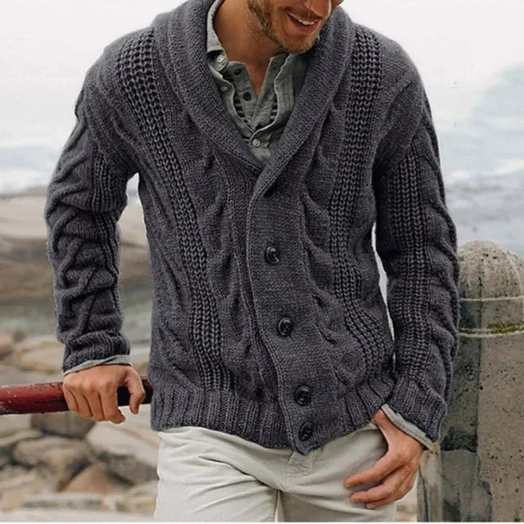 Dark gray men's cable knit cardigan featuring a sophisticated shawl collar & button-front, essential winter sweater.