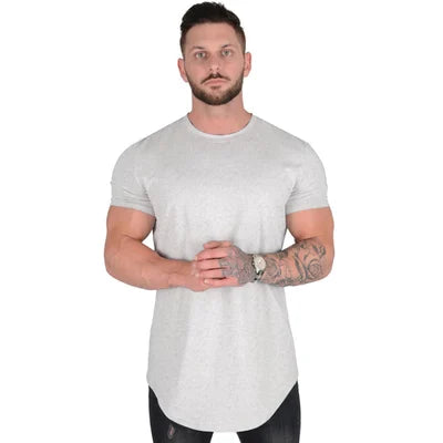 Model wearing grey men's deep cut t-shirt, showcasing comfortable stretch & modern fit.