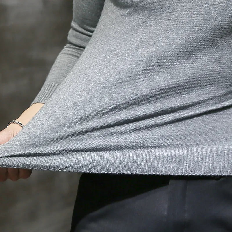 Detailed view of men's knit turtleneck sweater texture. High-quality long-sleeve pullover for winter comfort.