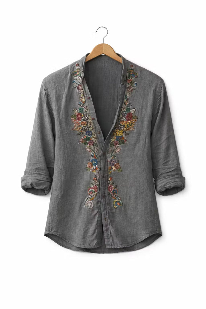 Men's relaxed fit V-neck shirt with vibrant floral embroidery, long sleeve, suitable for various occasions.
