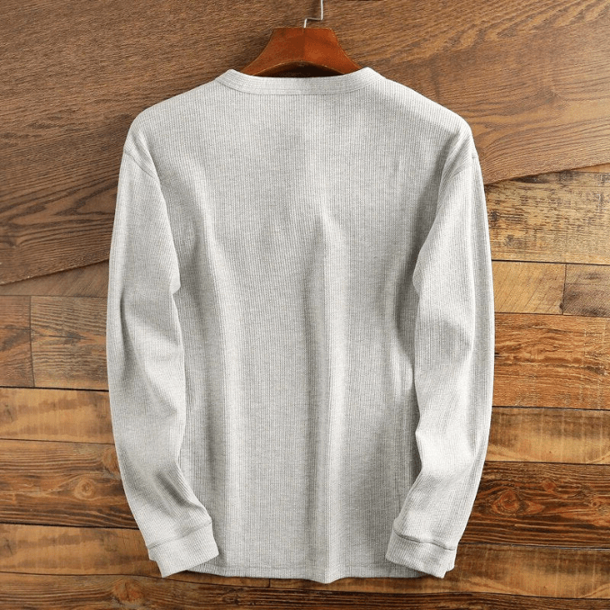 Textured waffle knit men's Henley top, long sleeve for everyday comfort and style.