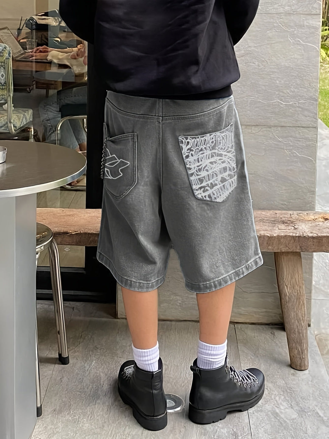 Men's loose fit denim Bermuda shorts with floral embroidery. Casual knee-length summer style.