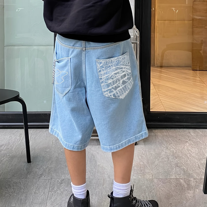Men's streetwear floral embroidered loose fit denim Bermuda shorts. Fashionable and relaxed.