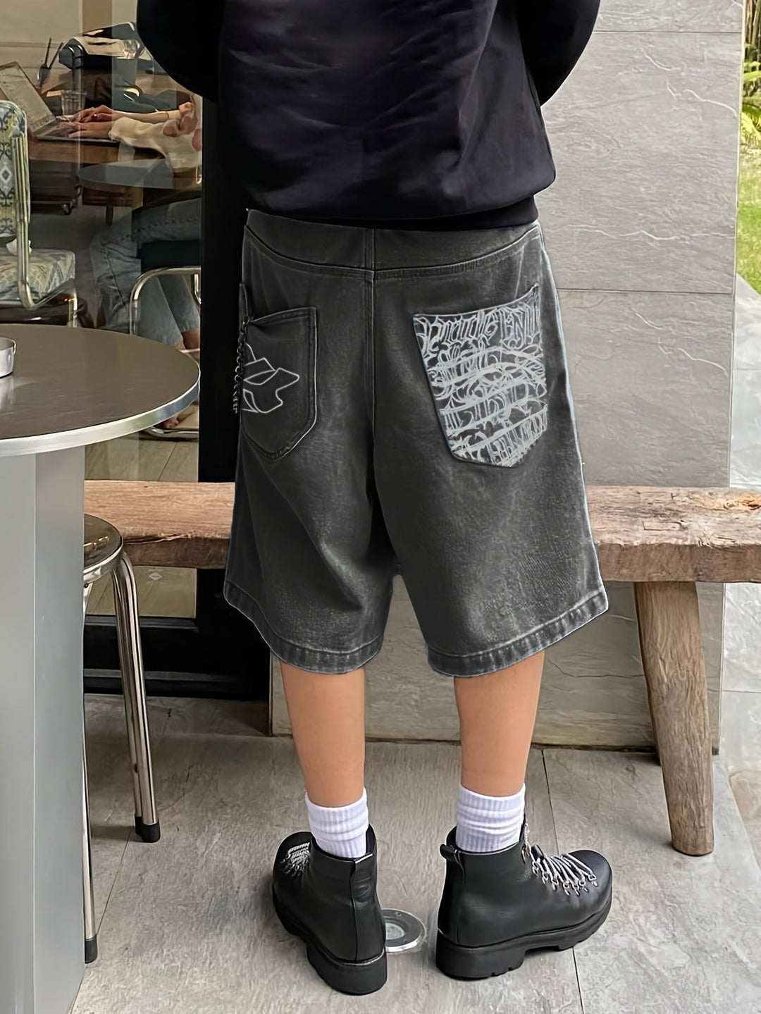 Streetwear men's loose fit Bermuda shorts, denim, with unique floral embroidery detail.