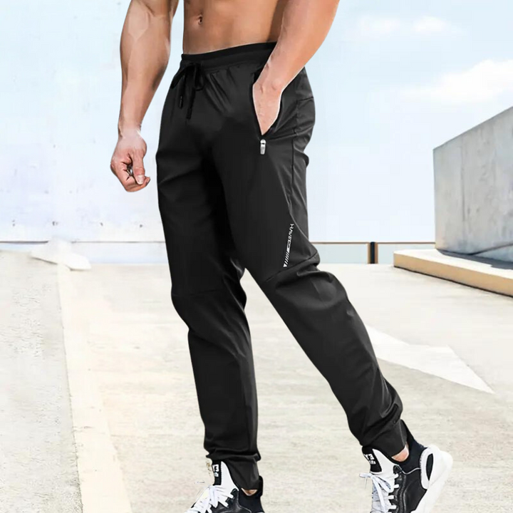 Men's performance training trousers in black, ideal for gym workouts, running, and athletic activities. Lightweight & breathable.