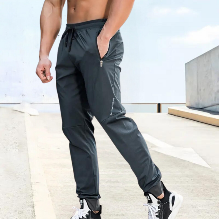 Flexible men's sports trousers for activewear. Breathable joggers provide comfort for training, running, and gym sessions.